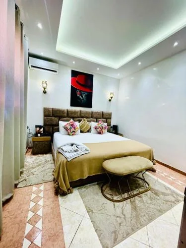 Riad Douirtna double bedroom with gold decor